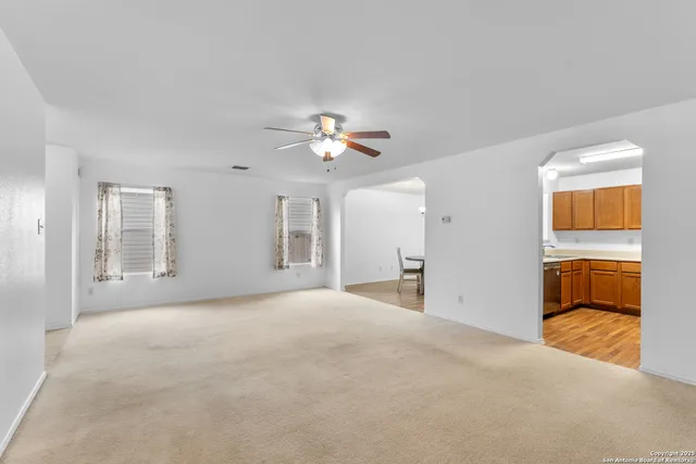 a view of a livingroom with a ceiling fan and window