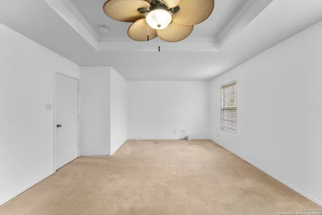 a view of an empty room and wooden floor