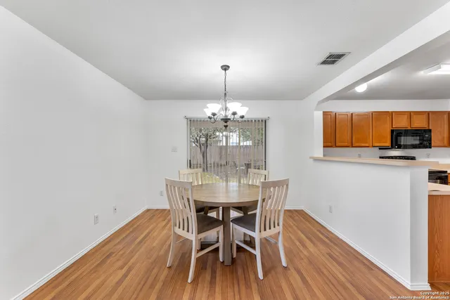 a dining room with furniture and wooden floor