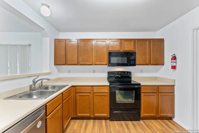 a kitchen with a sink stove and microwave