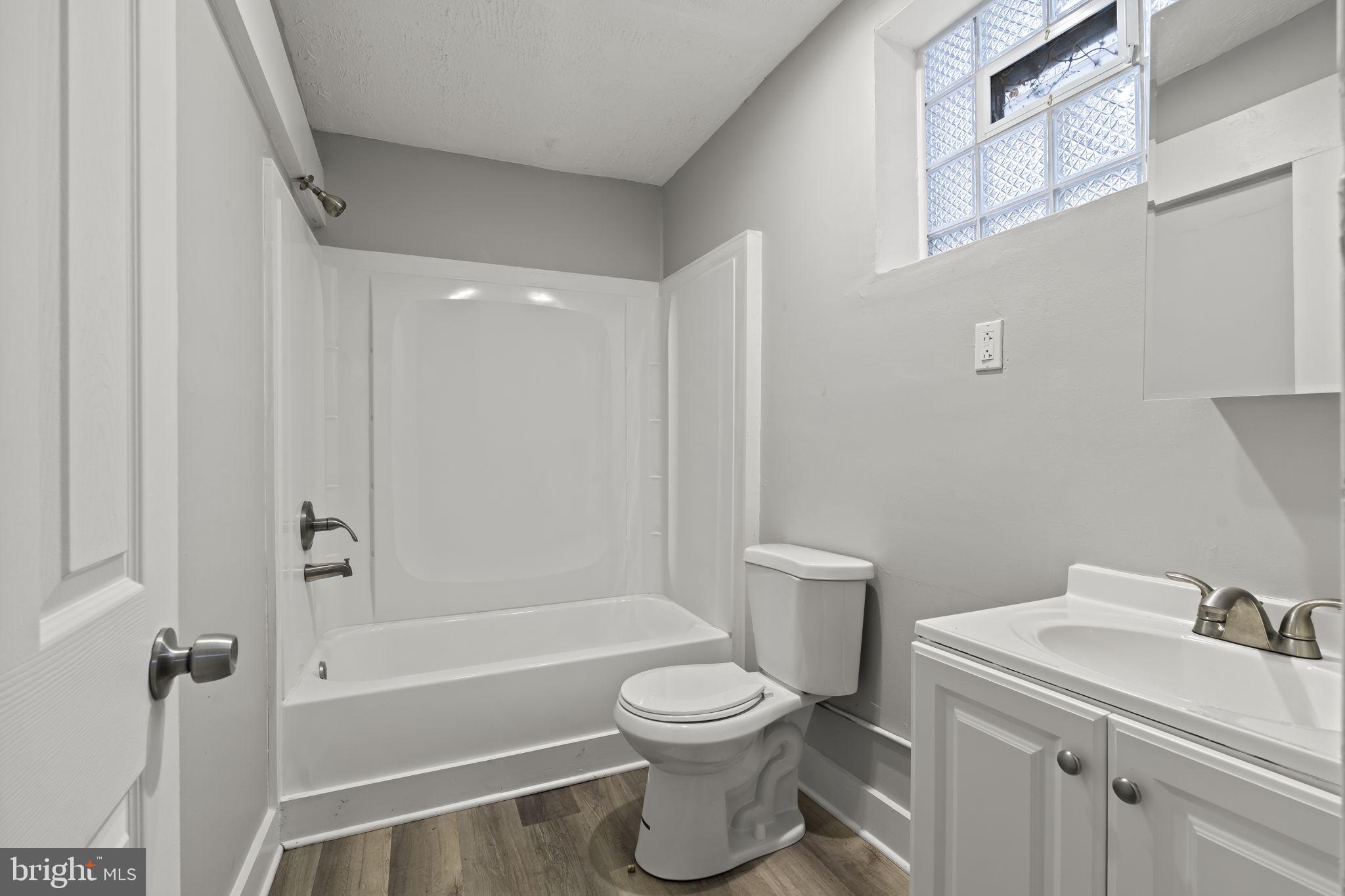 4630 Chester Avenue Philadelphia, PA 19143 - Photo 14 of 46 a bathroom with a toilet sink and mirror