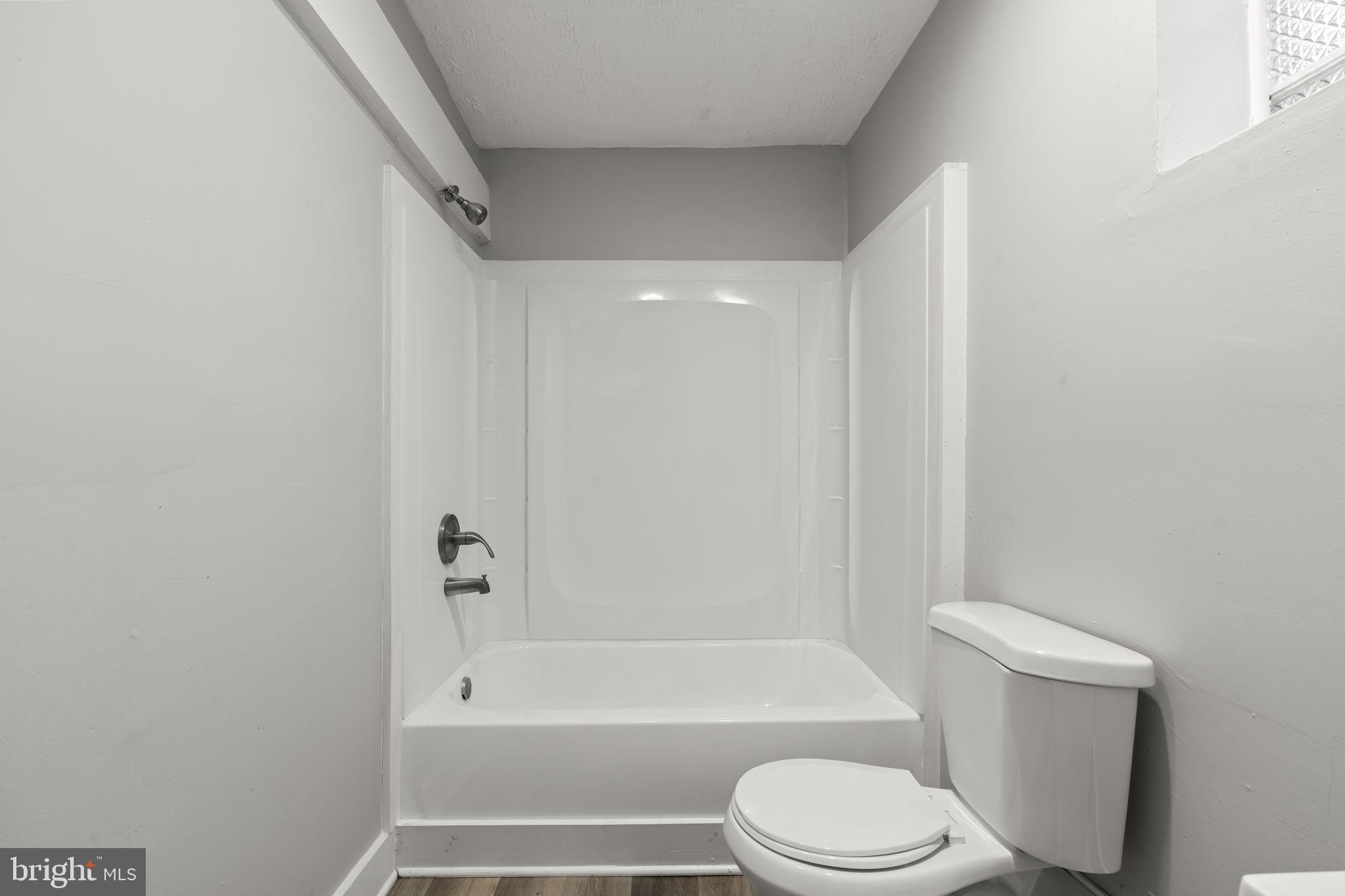 4630 Chester Avenue Philadelphia, PA 19143 - Photo 15 of 46 a bathroom with a toilet and a bathtub