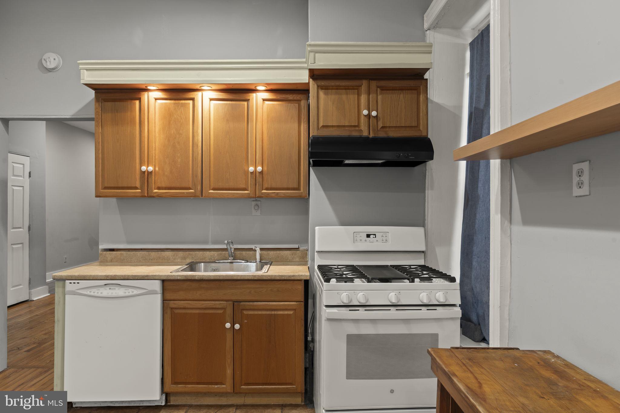 4630 Chester Avenue Philadelphia, PA 19143 - Photo 19 of 46 a kitchen with a stove and a microwave