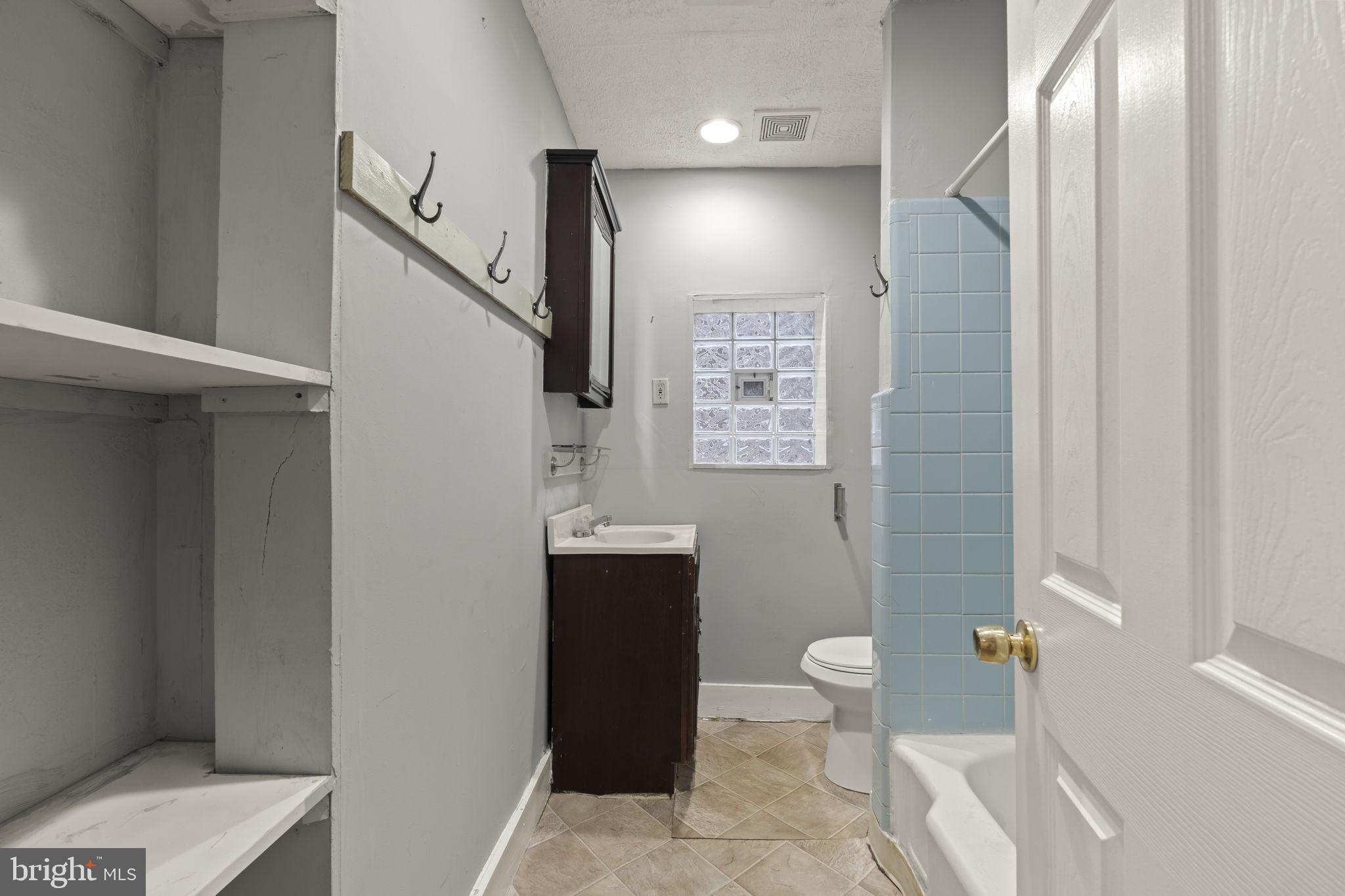 4630 Chester Avenue Philadelphia, PA 19143 - Photo 21 of 46 a bathroom with a toilet sink and a mirror