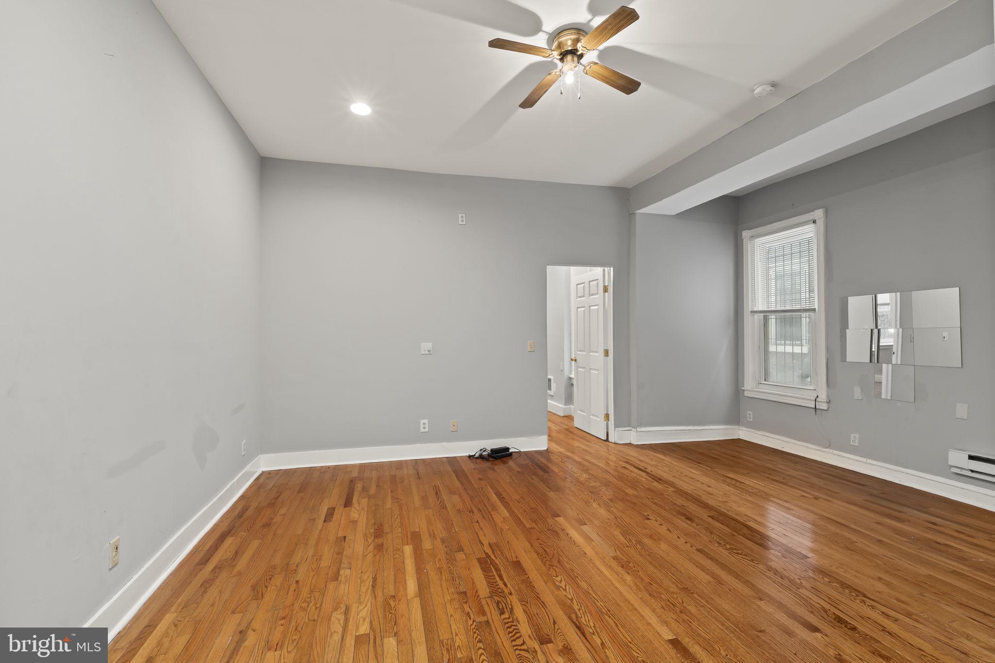 4630 Chester Avenue Philadelphia, PA 19143 - Photo 23 of 46 wooden floor in an empty room with a window