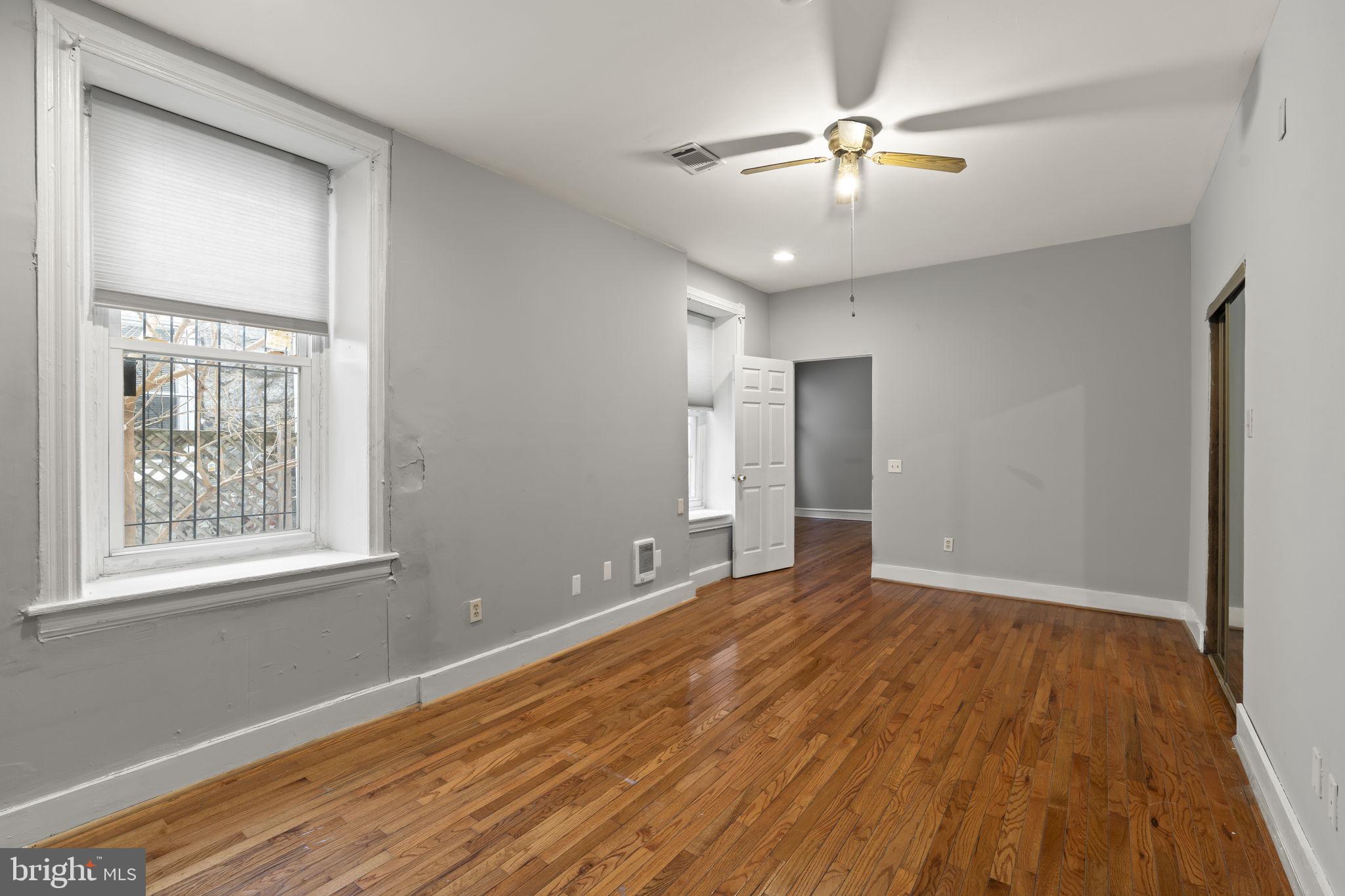 4630 Chester Avenue Philadelphia, PA 19143 - Photo 26 of 46 a view of an empty room with wooden floor and a window