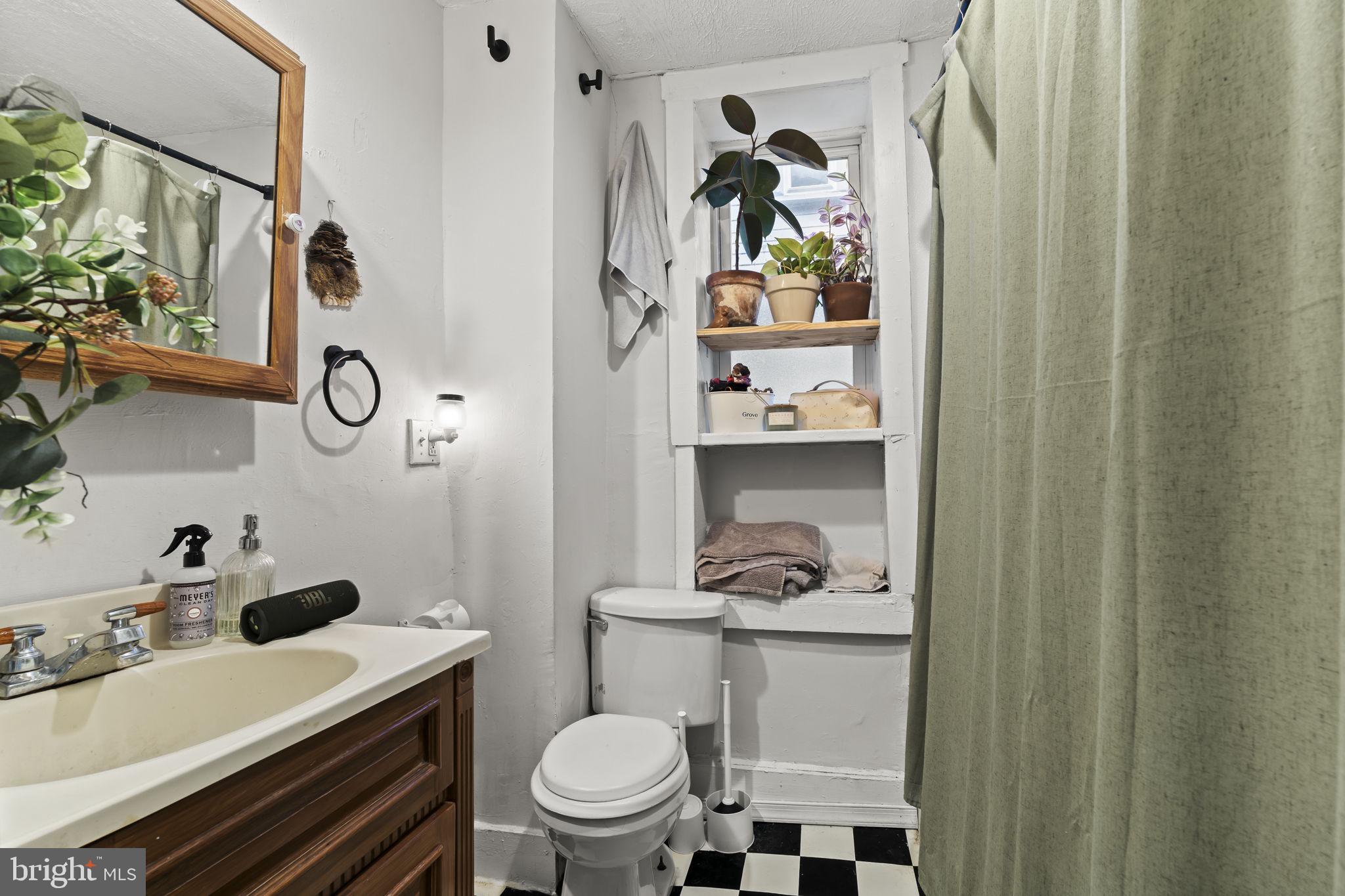 4630 Chester Avenue Philadelphia, PA 19143 - Photo 35 of 46 a bathroom with a sink toilet and a mirror