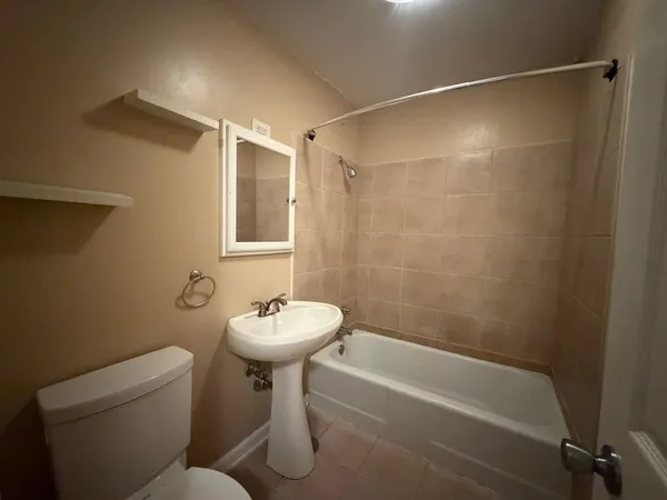 a utility room with wooden floor washer and dryer