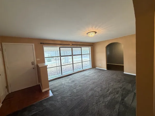 an empty room with windows and closet