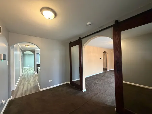 wooden floor in an empty room with a mirror