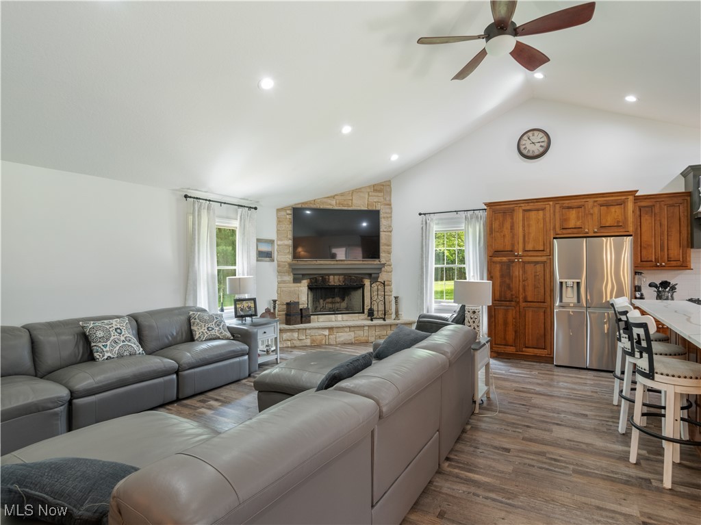 426 Bostic Road Gallipolis, OH 45631 - Photo 12 of 45 Living area with a ceiling fan, wood finished floors, a stone fireplace, recessed lighting, and high vaulted ceiling