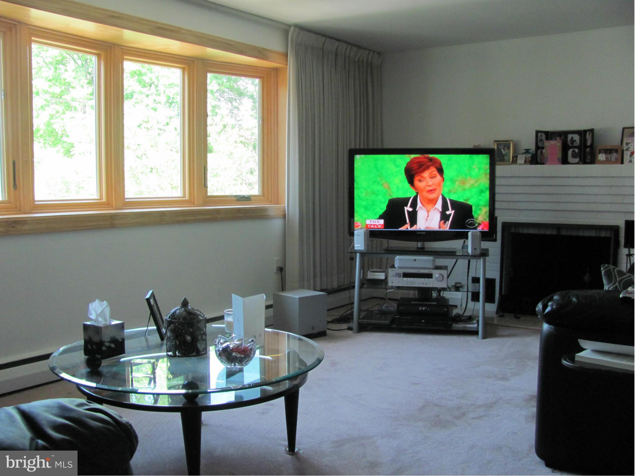 3645 Langrehr Road Baltimore, MD 21244 - Photo 11 of 25 a living room with furniture a flat screen tv and a fireplace