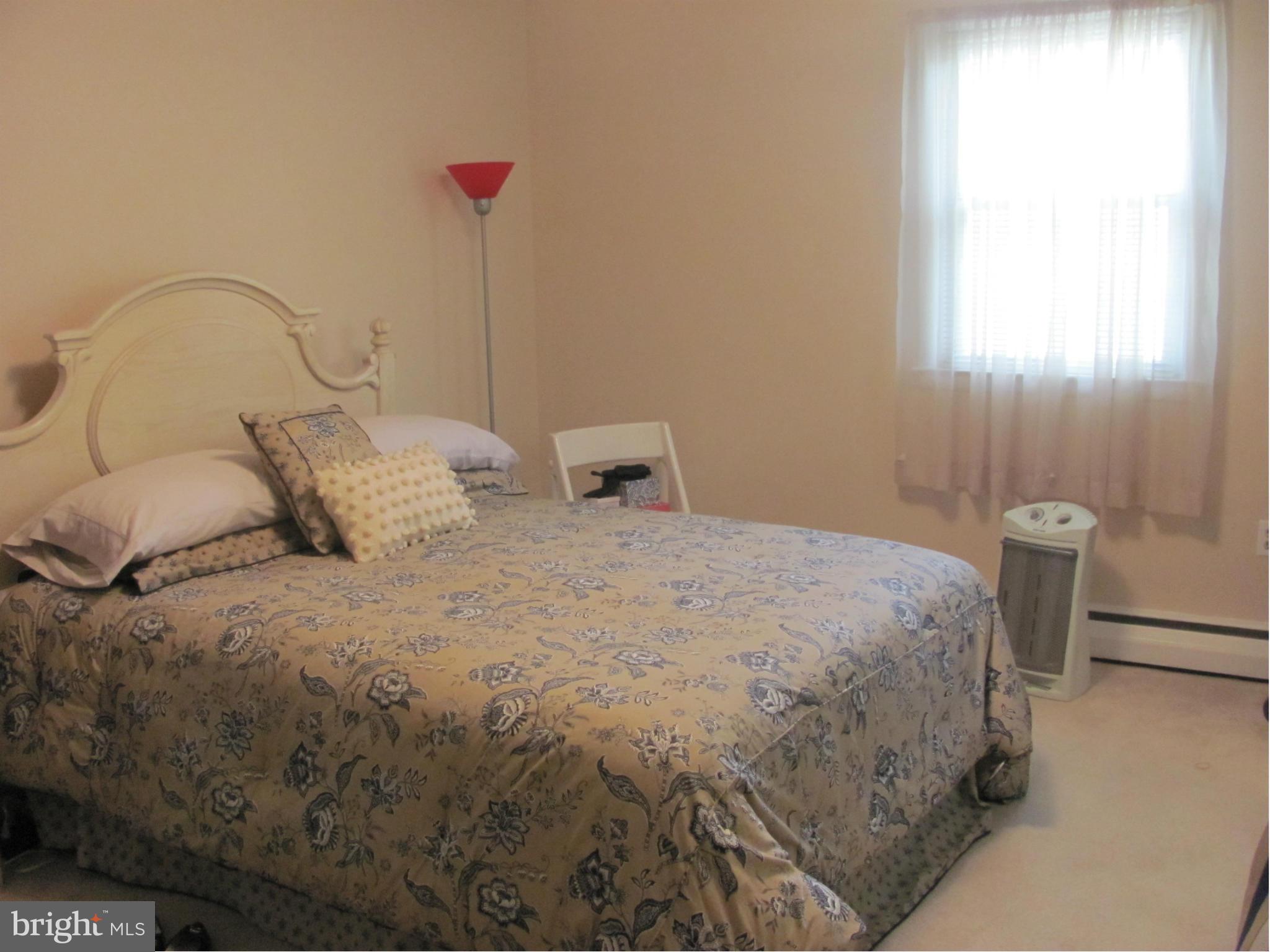 3645 Langrehr Road Baltimore, MD 21244 - Photo 14 of 25 a bedroom with a bed and a table