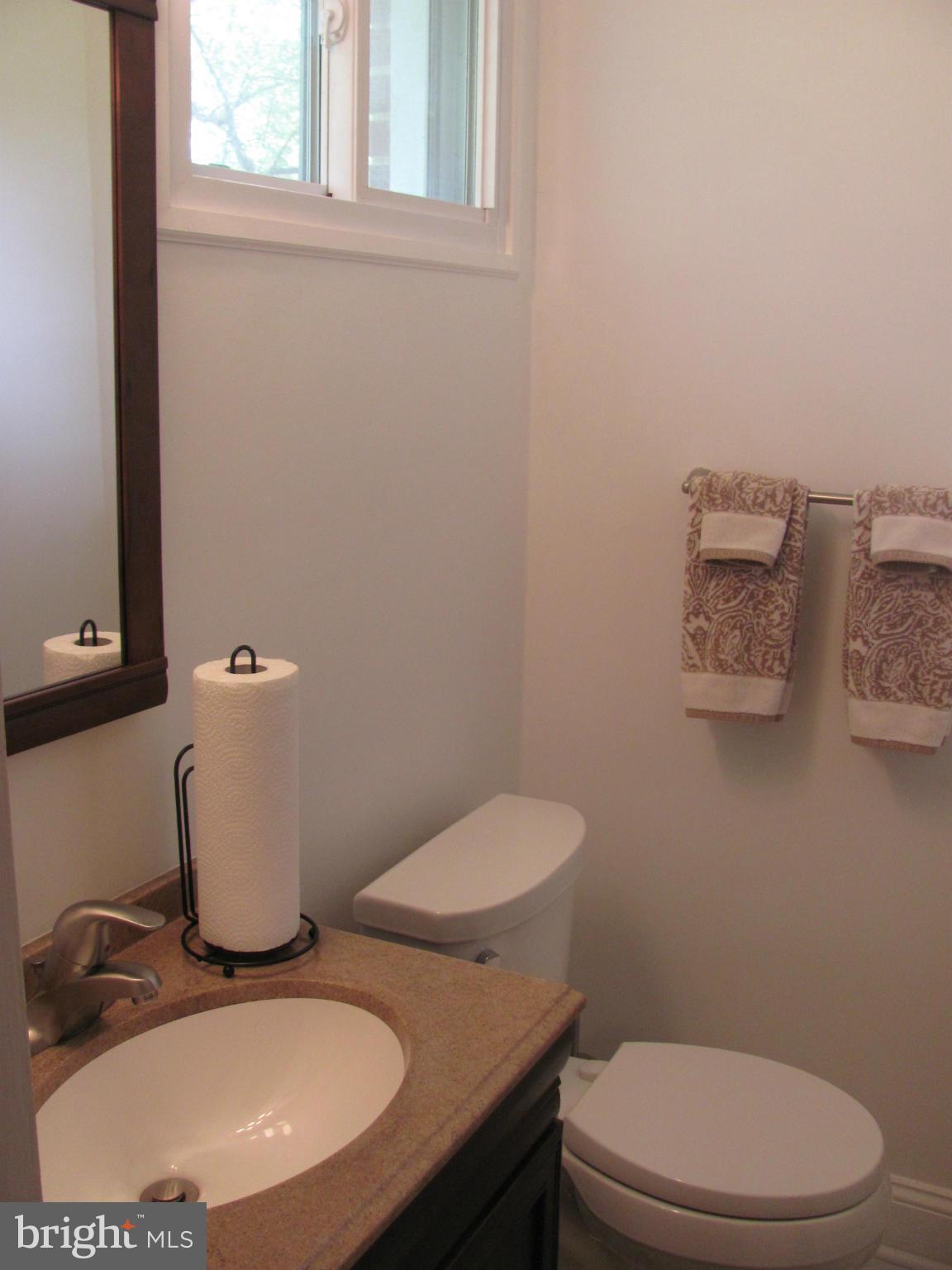 3645 Langrehr Road Baltimore, MD 21244 - Photo 16 of 25 a bathroom with a toilet a sink and mirror