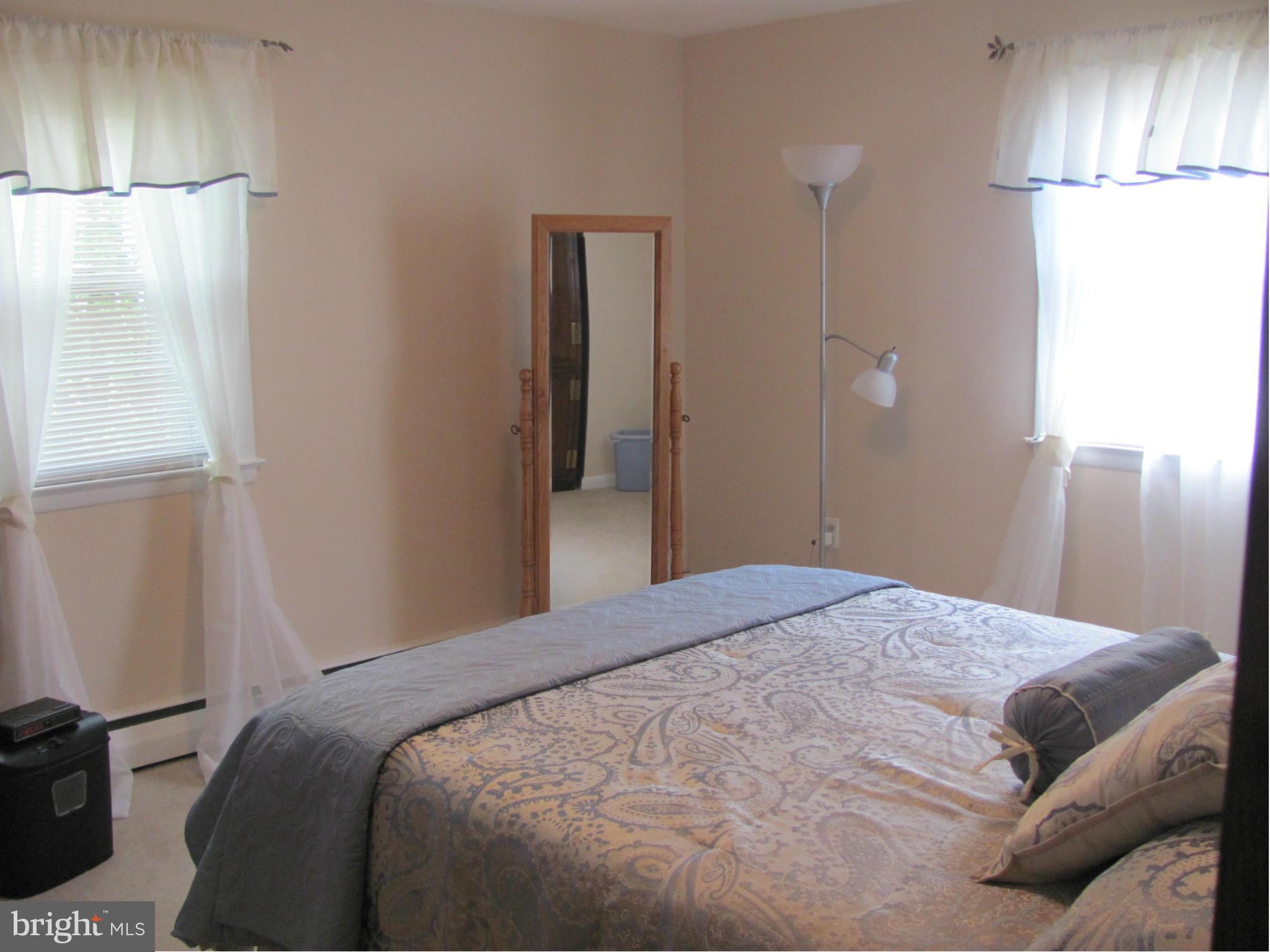 3645 Langrehr Road Baltimore, MD 21244 - Photo 18 of 25 a bedroom with a bed and a refrigerator