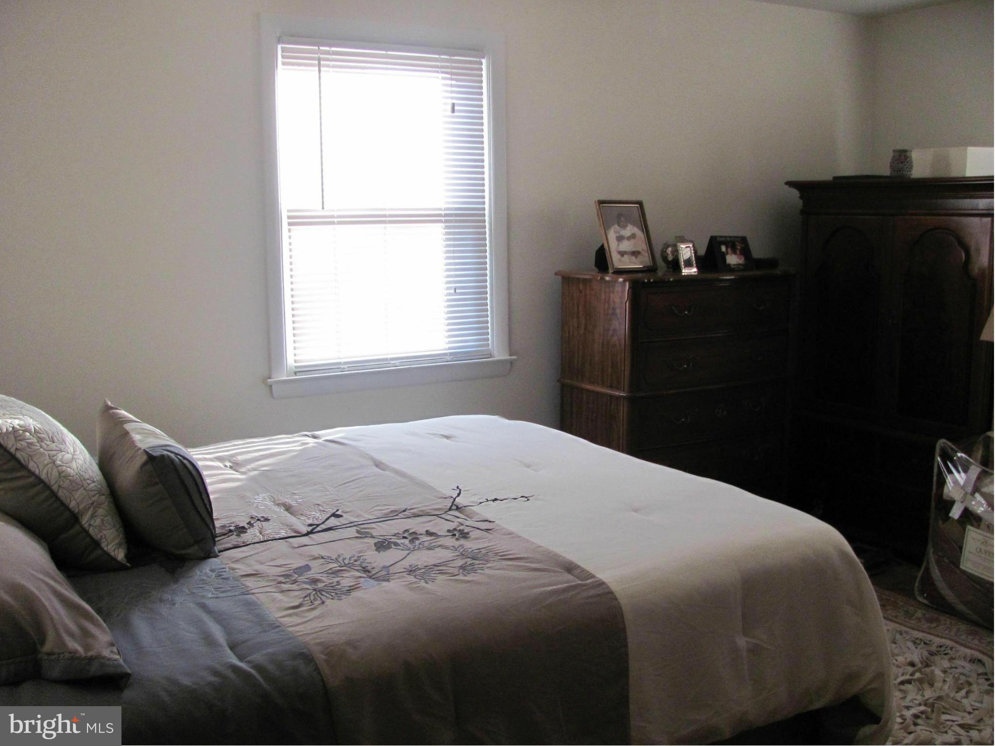 3645 Langrehr Road Baltimore, MD 21244 - Photo 19 of 25 a bedroom with a bed and dresser with window