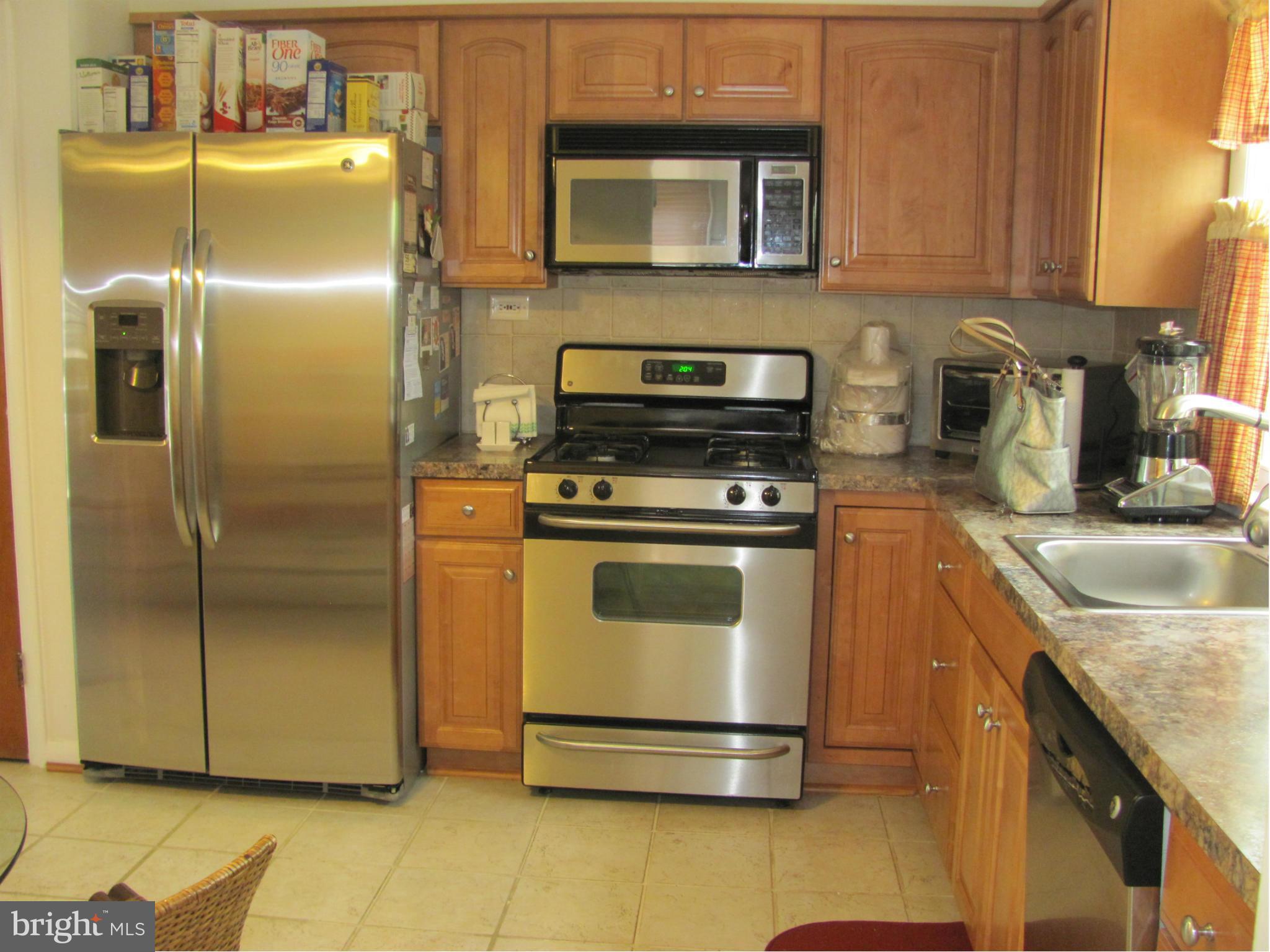 3645 Langrehr Road Baltimore, MD 21244 - Photo 8 of 25 a kitchen with granite countertop a refrigerator stove and sink