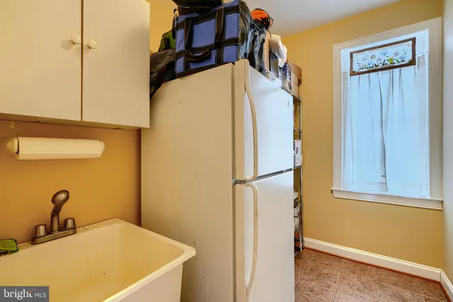 a bedroom with a bed and a lamp on dresser