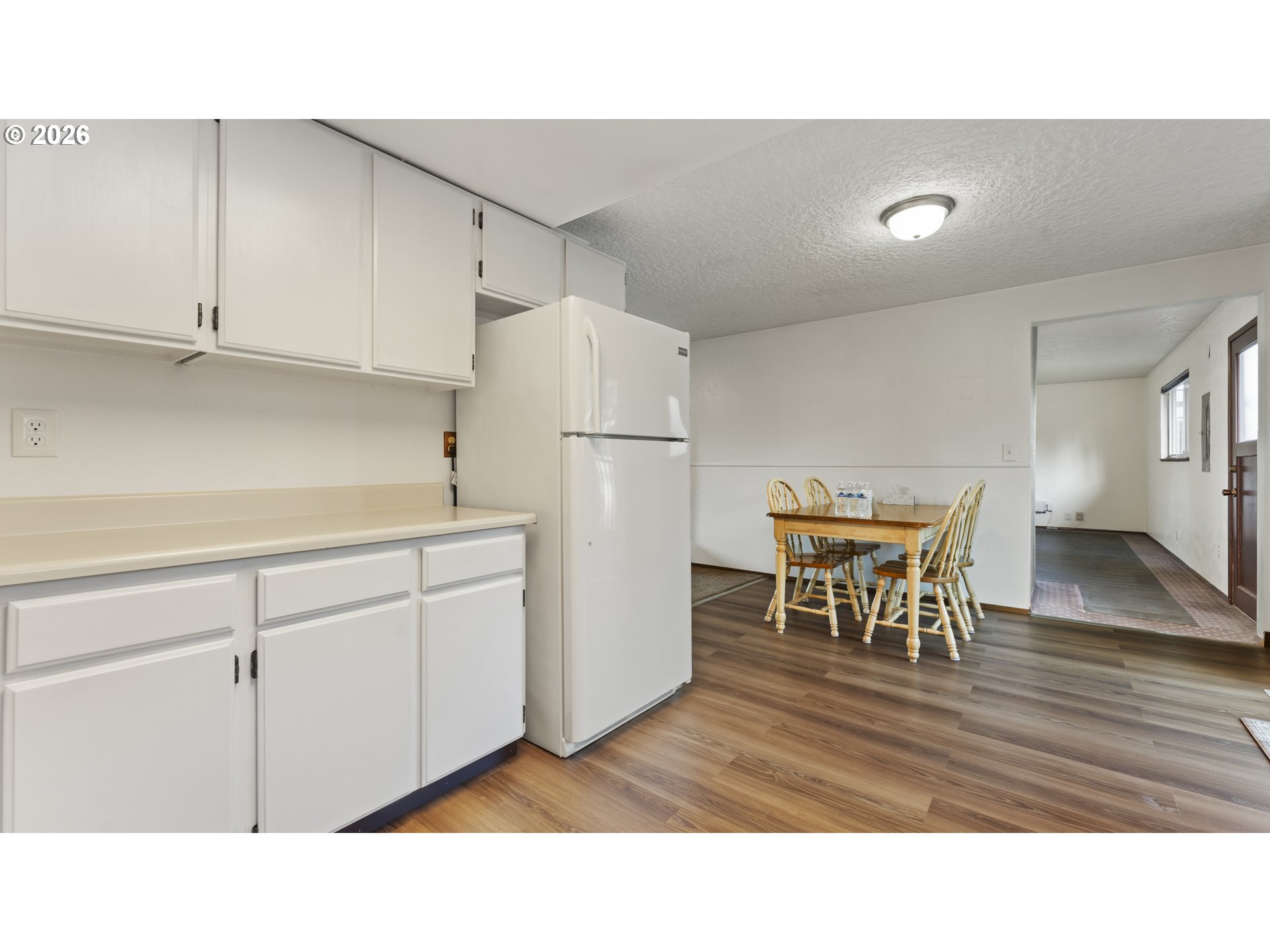 816 Northeast 193rd Avenue Portland, OR 97230 - Photo 5 of 28 a kitchen with a refrigerator and table