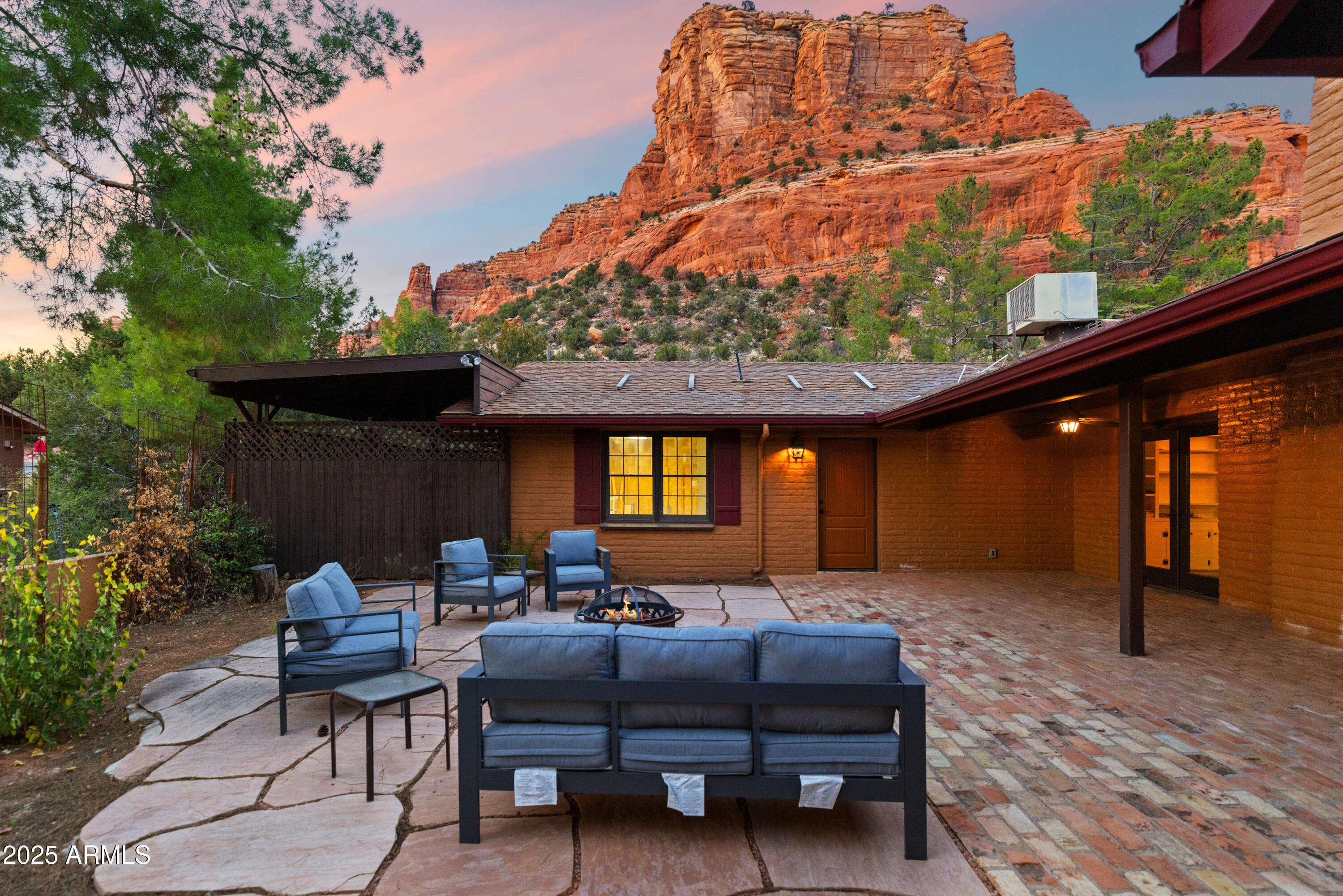 a backyard of a house with barbeque oven table and chairs