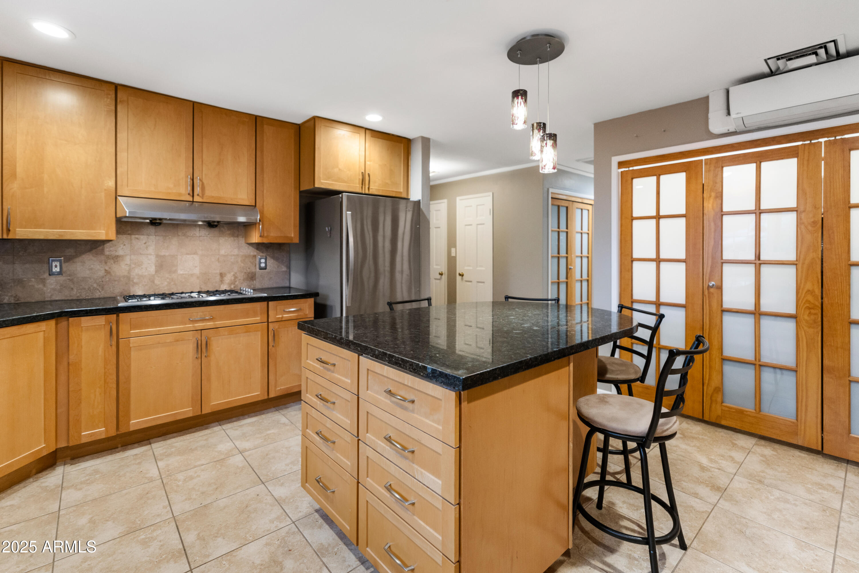 195 Courthouse Butte Road Sedona, AZ 86351 - Photo 14 of 31 a kitchen with stainless steel appliances granite countertop a stove a refrigerator a sink and white cabinets with wooden floor