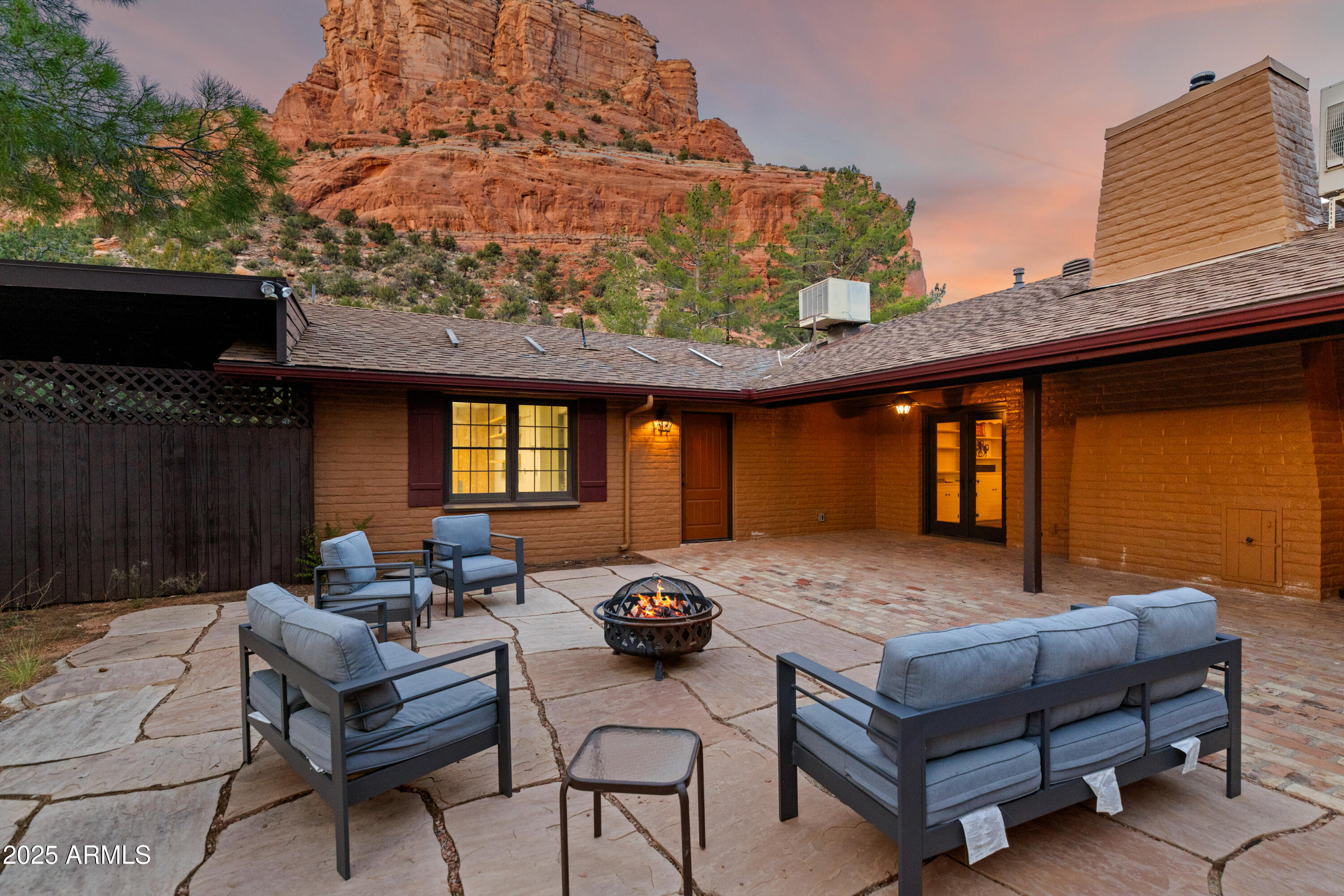 195 Courthouse Butte Road Sedona, AZ 86351 - Photo 18 of 31 a backyard of a house with barbeque oven table and chairs