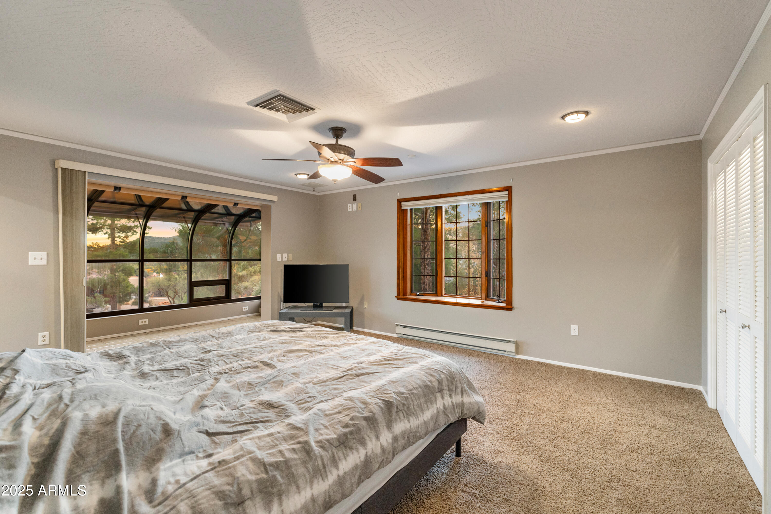 195 Courthouse Butte Road Sedona, AZ 86351 - Photo 21 of 31 a bedroom with a large bed and a large window