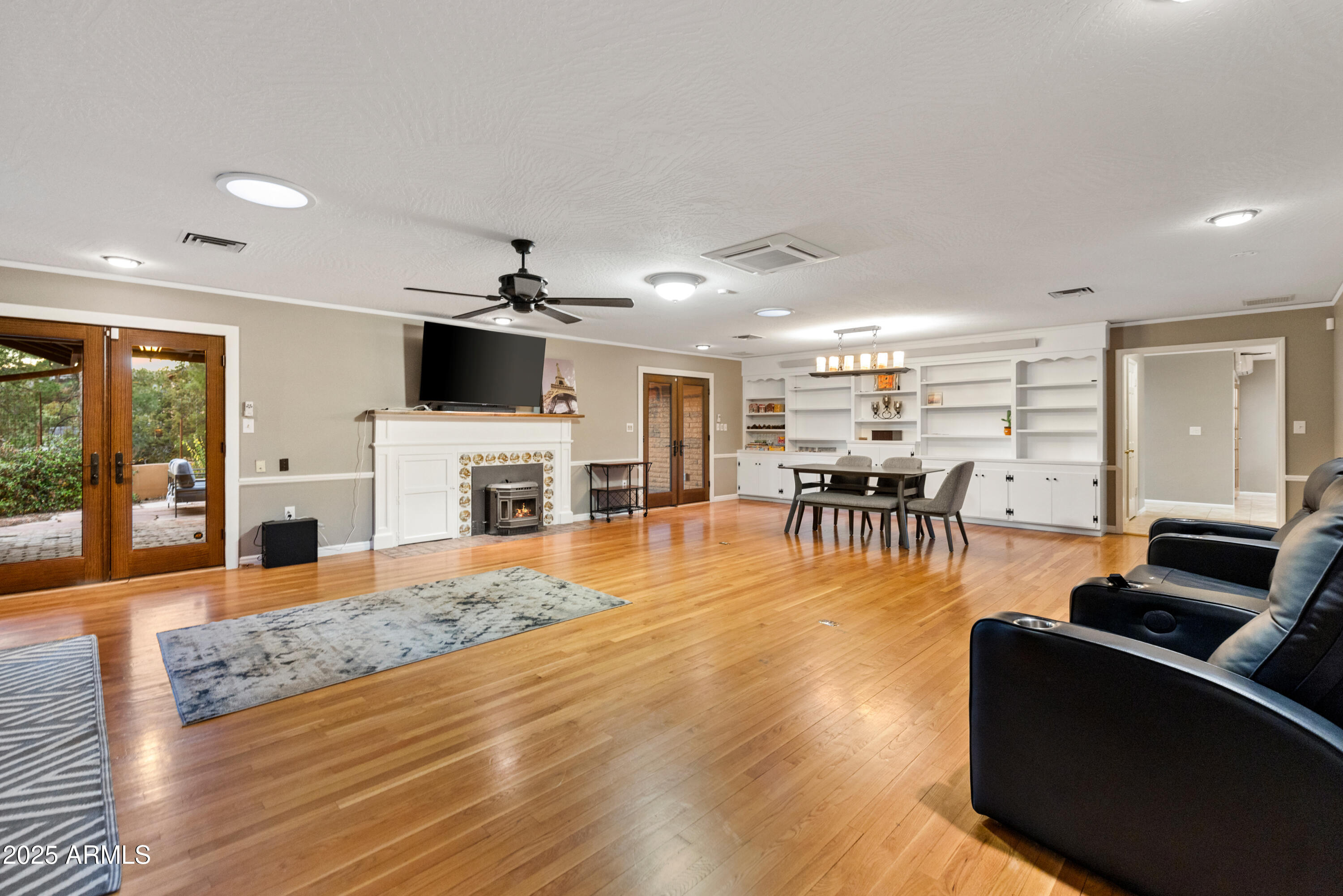 195 Courthouse Butte Road Sedona, AZ 86351 - Photo 9 of 31 a living room with furniture a fireplace and a flat screen tv