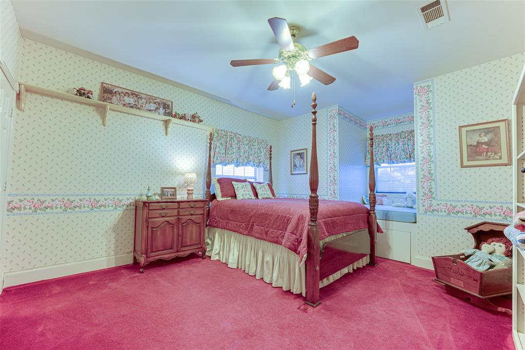 707 Cullins Road Rockwall, TX 75032 - Photo 21 of 35 a spacious bedroom with a bed and a chandelier