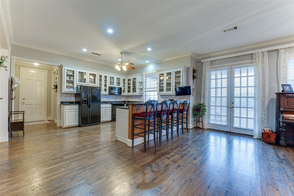 707 Cullins Road Rockwall, TX 75032 - Photo 25 of 35 a open kitchen with stainless steel appliances granite countertop a refrigerator oven dining table and chairs
