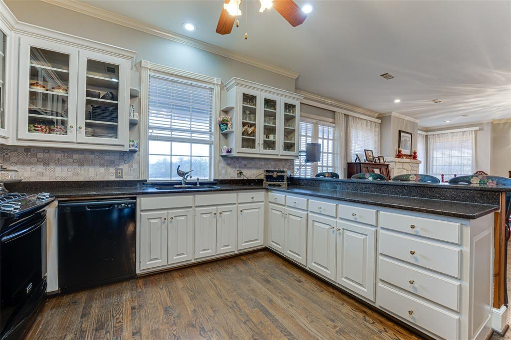707 Cullins Road Rockwall, TX 75032 - Photo 28 of 35 a kitchen with granite countertop cabinets stainless steel appliances a sink and a window