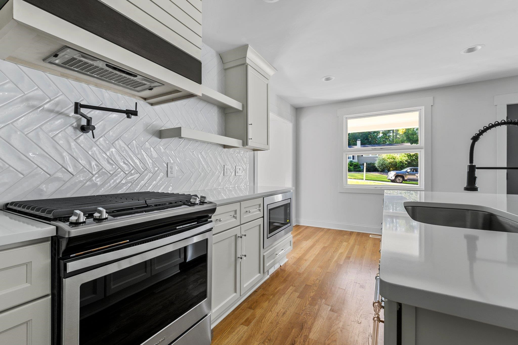 317 Quail Drive Raleigh, NC 27604 - Photo 16 of 29 Custom Built Hood Vent + Open Shelves. Gas Range + Pot Filler Kitchen