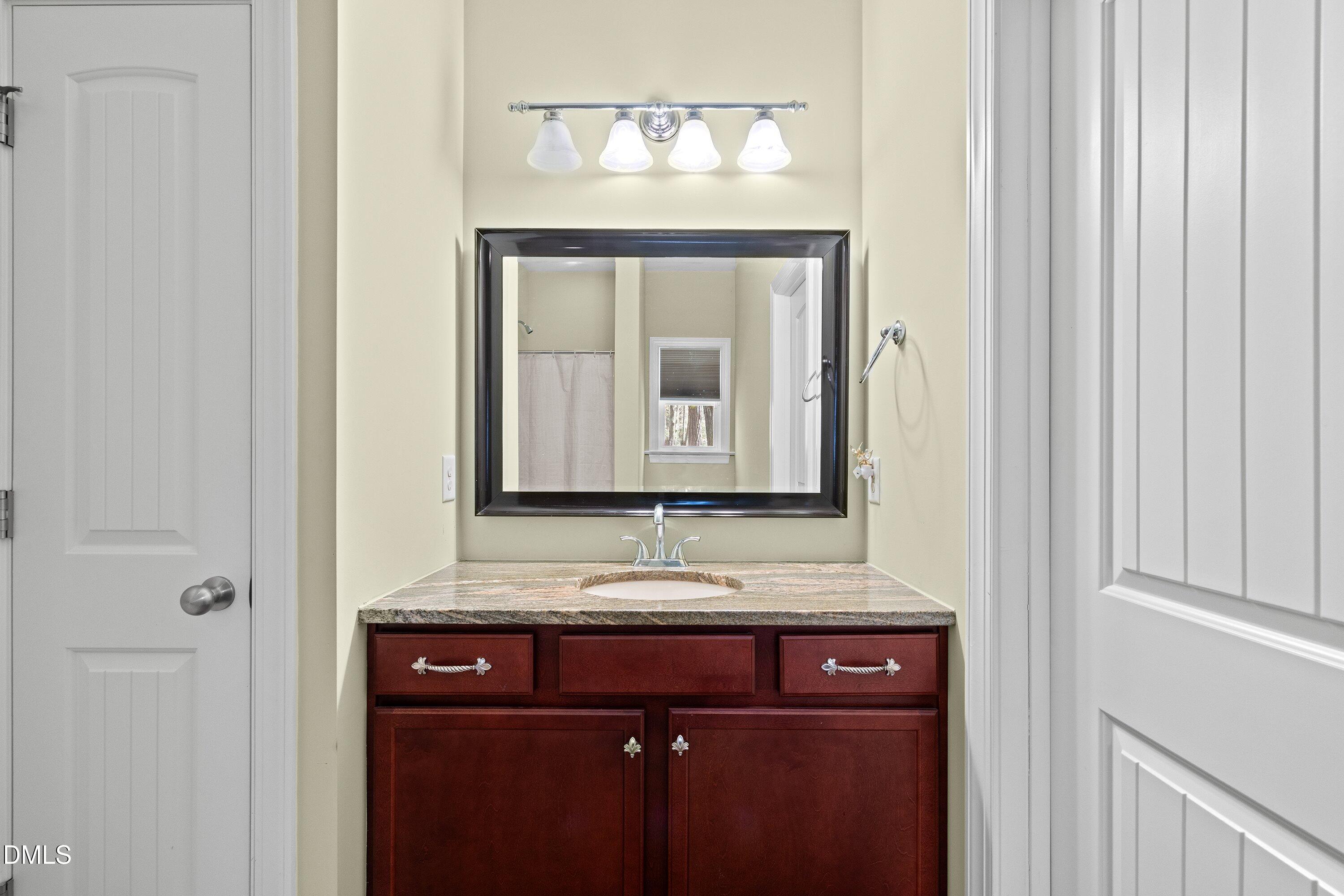 9713 Lake Wheeler Road Raleigh, NC 27603 - Photo 15 of 18 a bathroom with a sink and a mirror