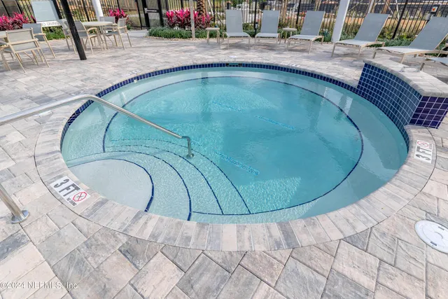 a view of a swimming pool with outdoor seating