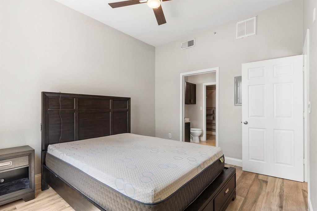 3102 Kings Road, Unit 1106 Dallas, TX 75219 - Photo 12 of 20 a large bed sitting in a bedroom next to a window