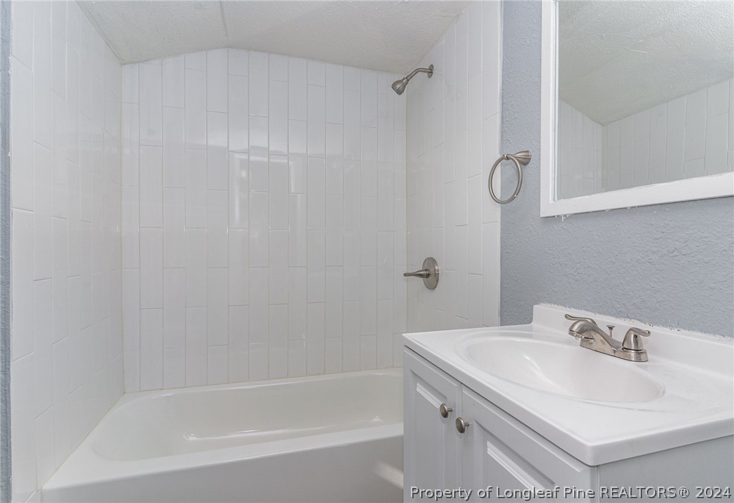 1218 Boyer Street Raleigh, NC 27610 - Photo 12 of 12 a bathroom with a sink and a bathtub