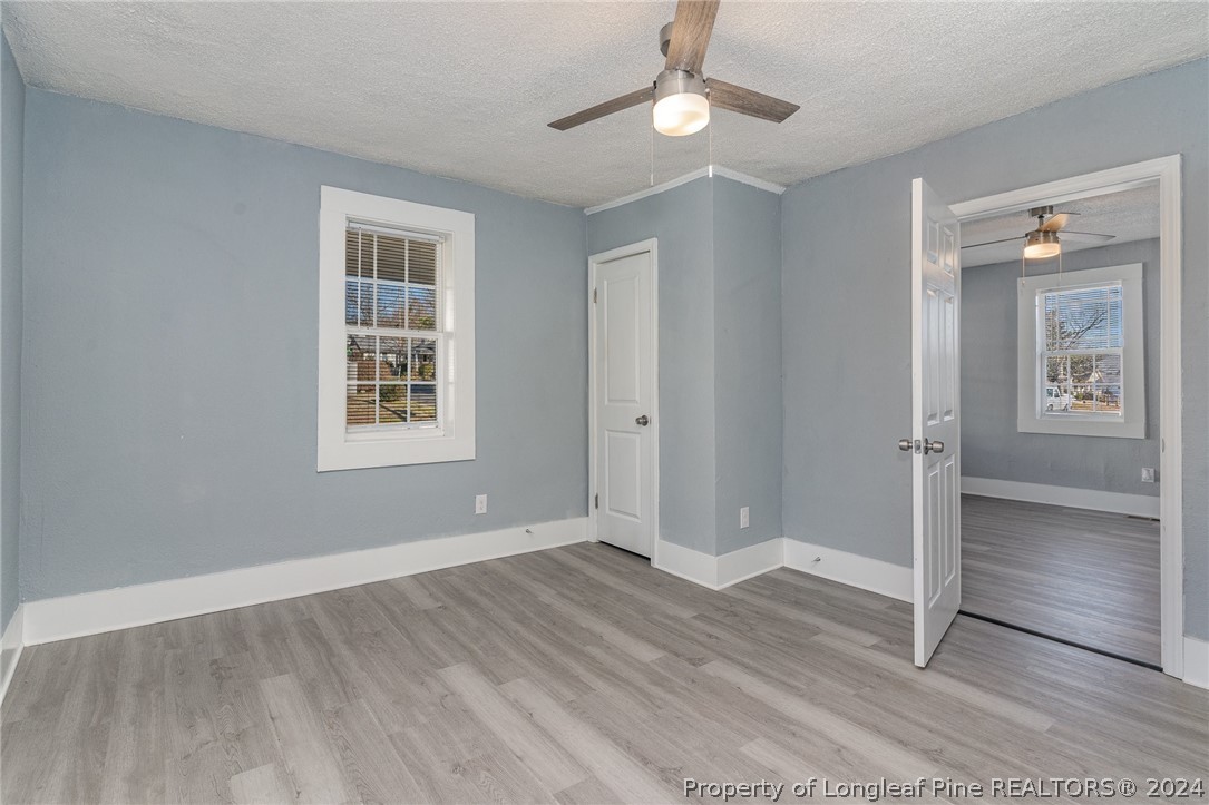 1218 Boyer Street Raleigh, NC 27610 - Photo 6 of 12 wooden floor in an empty room with a window