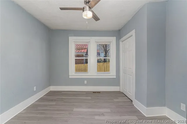 wooden floor in an empty room with a window