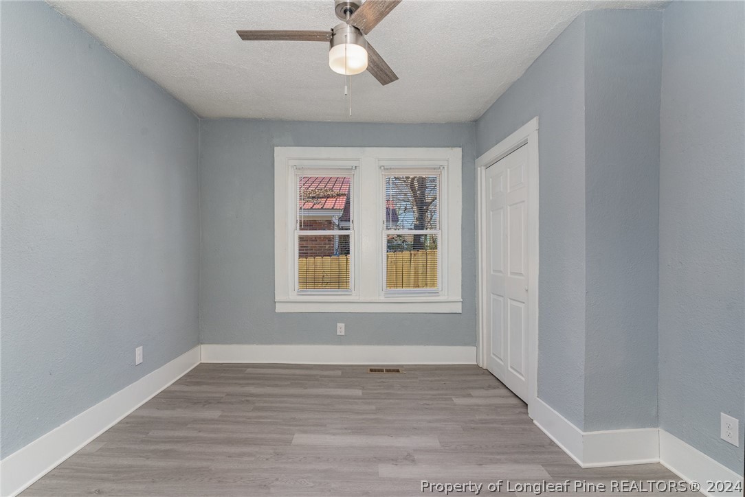 1218 Boyer Street Raleigh, NC 27610 - Photo 7 of 12 wooden floor in an empty room with a window