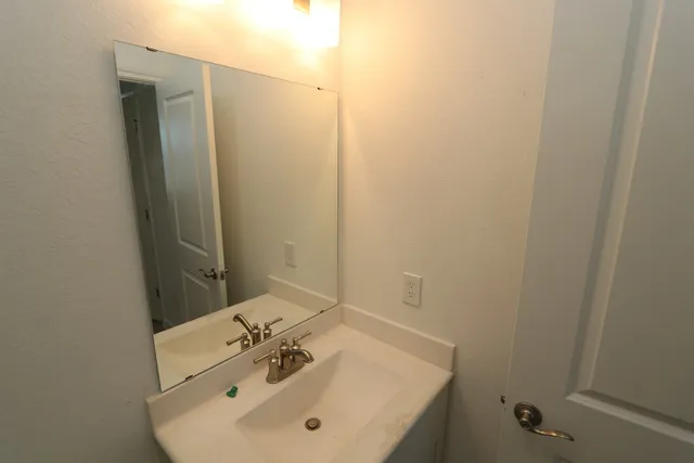 a bathroom with a sink and mirror