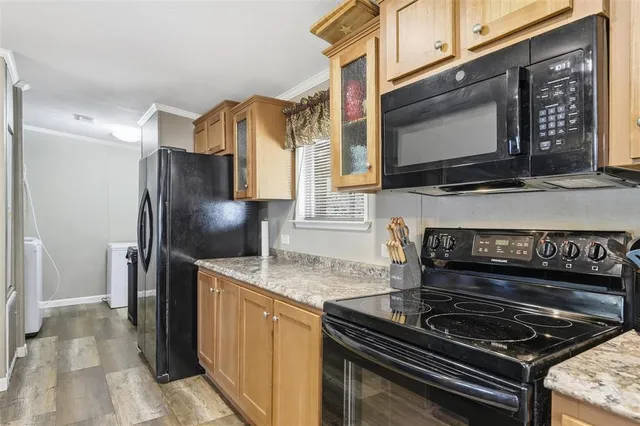 a kitchen with stainless steel appliances granite countertop a stove microwave and refrigerator