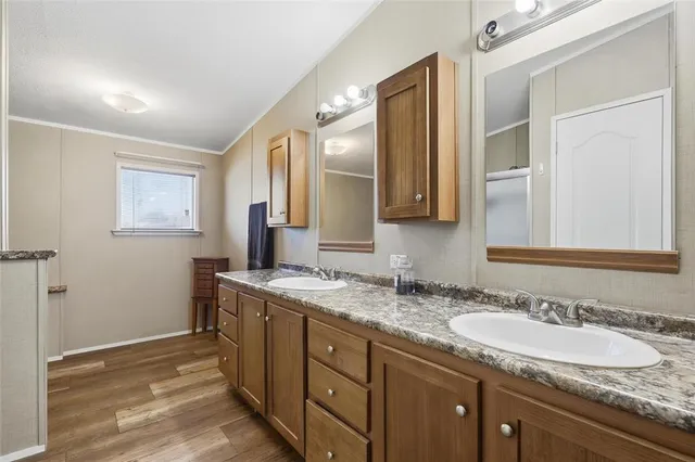 a bathroom with a granite countertop sink double and mirror