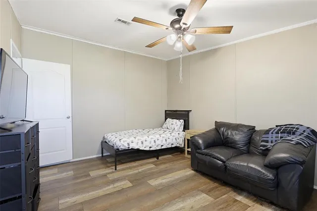 a bedroom with furniture and a chandelier