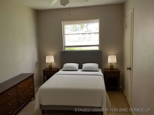 a bedroom with a bed and a window