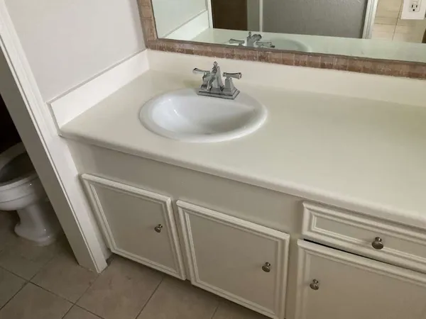 a close view of a sink and a vanity in the bathroom