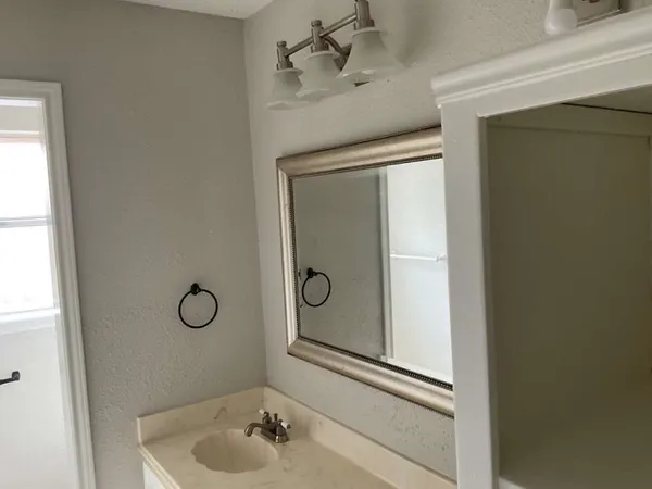 a bathroom with a shower and mirror