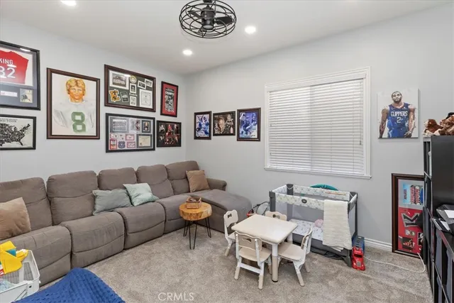 a kitchen with stainless steel appliances a refrigerator a stove a sink dishwasher and a dining table with wooden floor