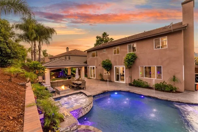 a view of a house with backyard porch and sitting area