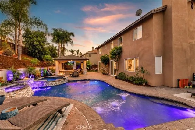a view of a patio with couches table and chairs and potted plants