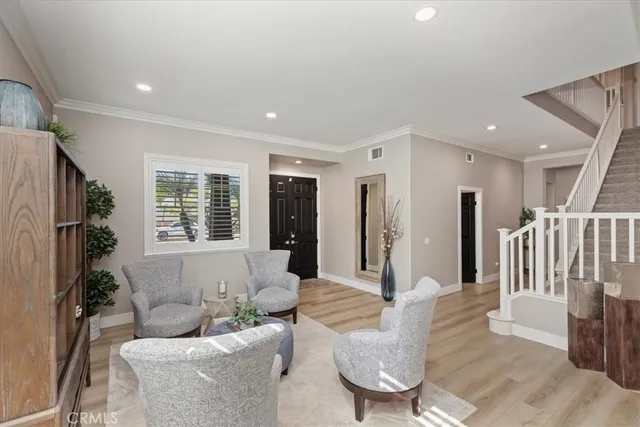 a view of staircase with wooden floor and white walls